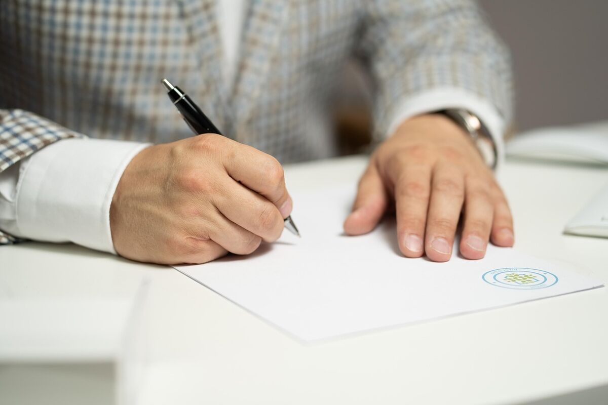 Client signing a retainer agreement with a pen